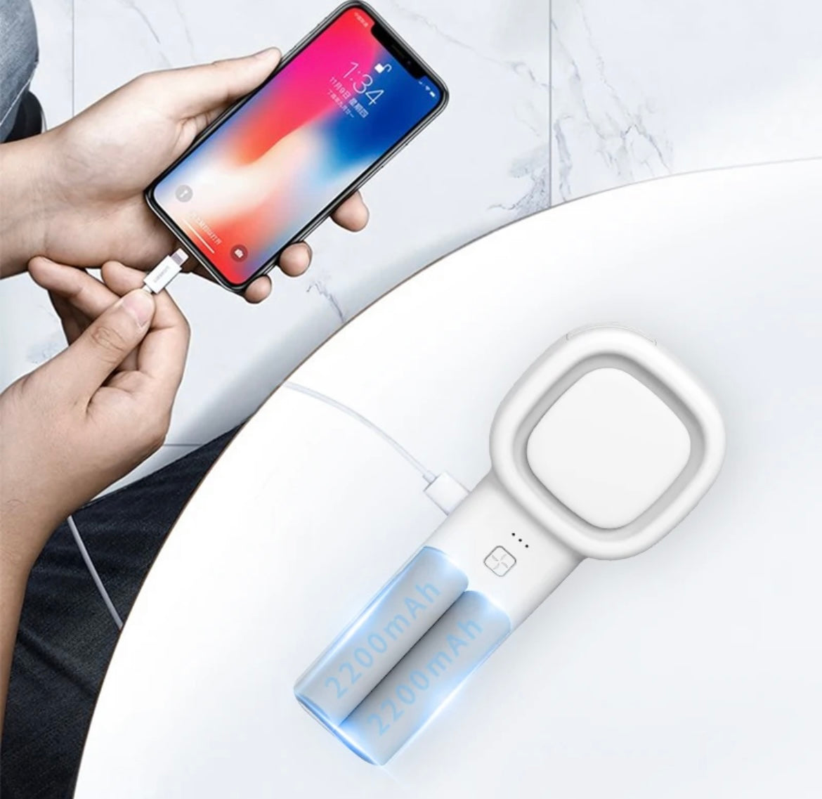 image of someone plugging their phone into the lash fan